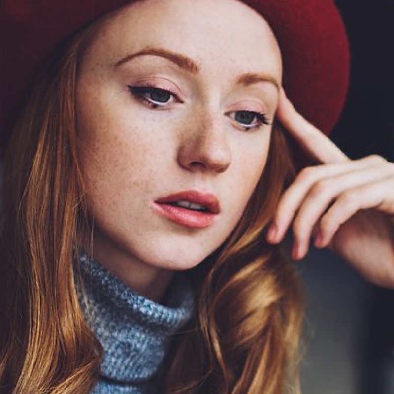 calm-female-freelancer-using-phone-and-looking-at-2023-11-27-05-30-17-utc.jpg